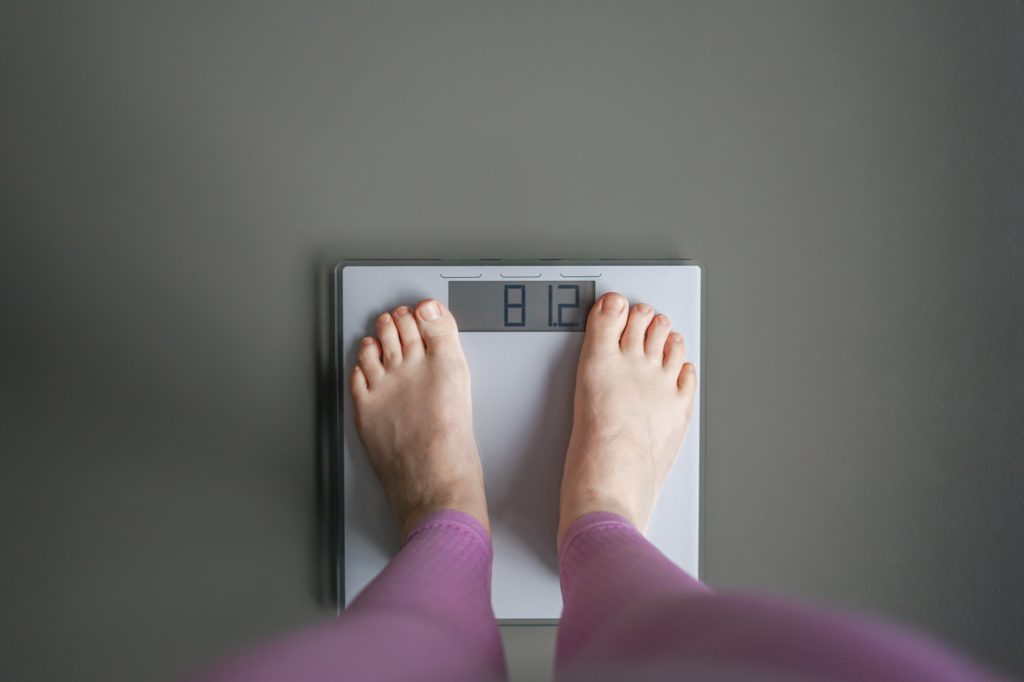 Woman watching her weight . Weight loss. Healthy weight.