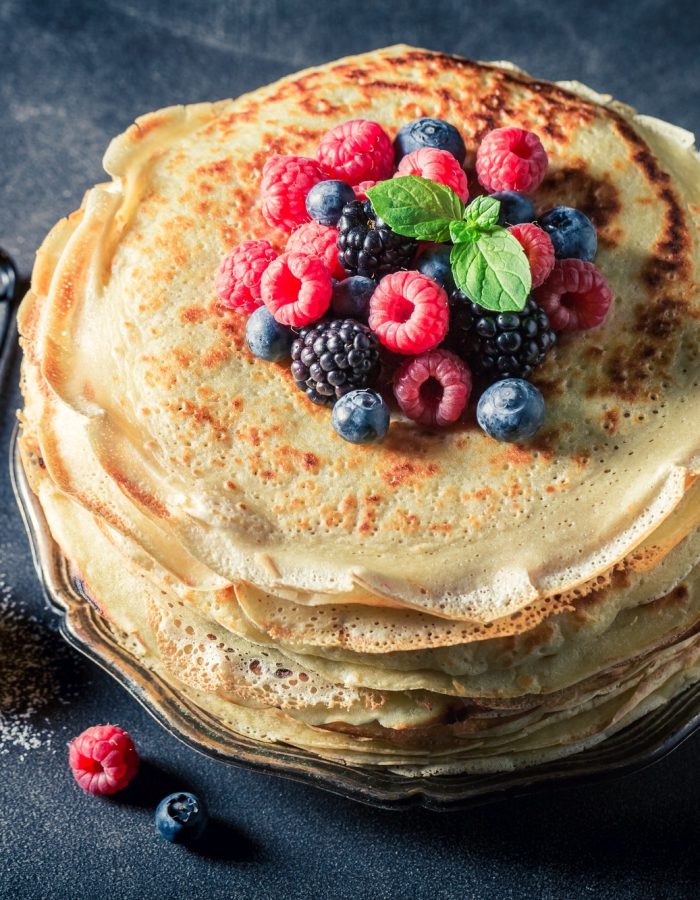 Fresh pancakes with blueberries and raspberries. Pancakes for breakfast.