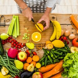 Top view of woman chef cutting and preparing food