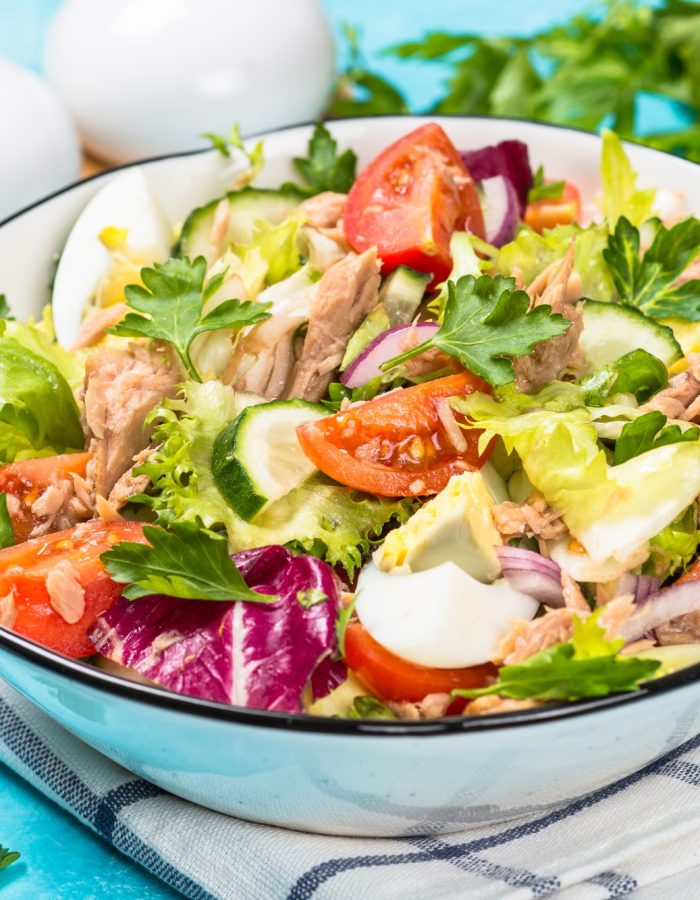 Tuna salad with green leaves, eggs and vegetables